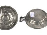 pair of silver plated bowls with handles and handles on a white background