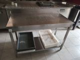 a kitchen island with a sink and a trash can on it