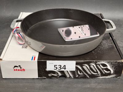 a frying pan sitting on top of a box on a table