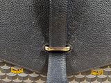 a close up of a black and yellow bag on a wooden table