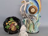 two vases and a figurine sitting next to each other