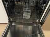 a dishwasher with a lot of dishes inside of it