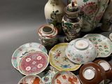 many different types of vases and plates on the table