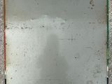 a mirror on the floor that is dirty and needs to be cleaned