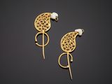 a pair of gold earrings with pearls on them