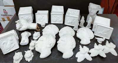 a lot of white figurines sitting on a table