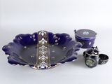 a blue bowl and two cups sitting on a table