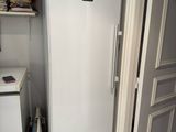 a white refrigerator in the corner of a room