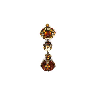 a close up of a pair of earrings on a white surface
