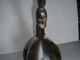 a metal spoon sitting on top of a black stand