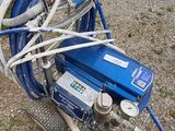 an image of a blue air compressor with hoses attached to it