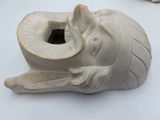 a white vase with an elephant head on it ' s side