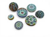 a lot of different colored glass beads on a white surface