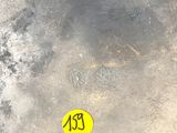 a yellow sticker that is on the ground next to a fire hydrant