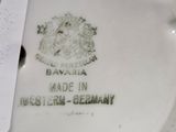 a white porcelain figurine with a tag on it