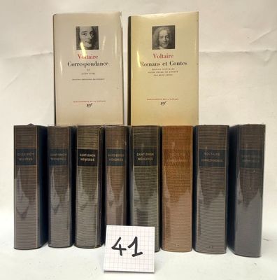 several books are lined up on a table with a number of them
