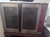 two ovens that are sitting on top of a wooden table