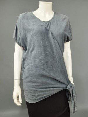 an image of a mannequin wearing a grey top and black skirt