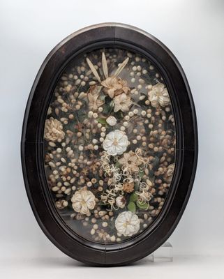 a picture of a picture of flowers in a black oval frame