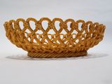 yellow wicker basket with handles and handles on a white surface