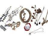 many different types of jewelry on display on a white surface