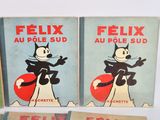 three books of felix the cat and felix the cat are on a table