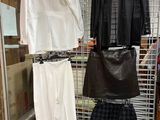 three pieces of clothing hanging on a rack in a store
