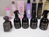 several bottles of different types of perfume are lined up on a table