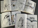a lot of books that are open on a table