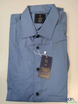 a close up of a blue shirt with a tag on it