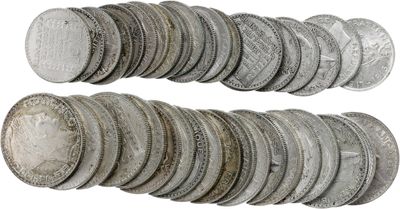 a close up of a pile of silver coins on a white background