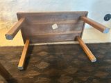 a wooden chair that is sitting on a carpet