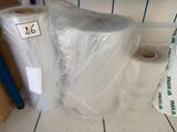 many rolls of plastic wrap on the floor next to a roll of toilet paper