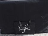 a black bag with a name on it sitting on the ground