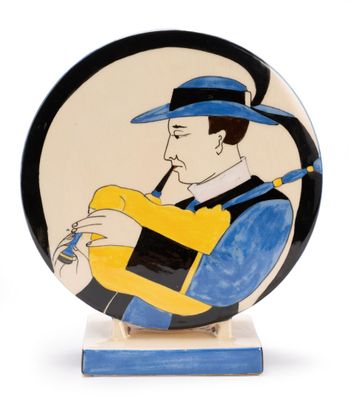 a picture of a decorative plate with a man playing a guitar