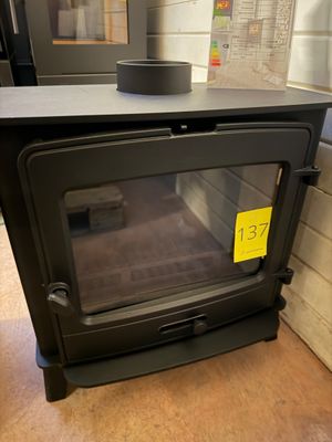 a black stove with a yellow sticker on it