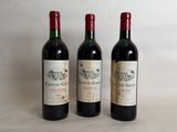 three bottles of wine sitting on top of a table next to each other