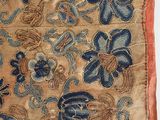 a close up of a piece of cloth with blue flowers on it