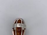 a silver ring with a brown stone inside of it