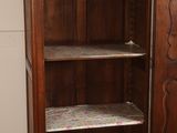 a wooden cabinet with a shelf on top of it in a room