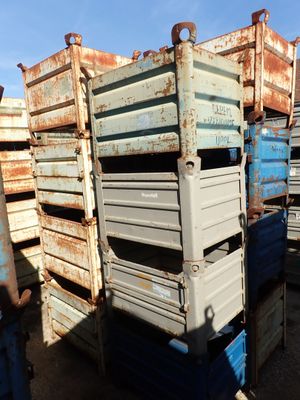 many crates stacked on top of each other in the dirt