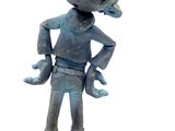 a statue of a boy with a bird on his head