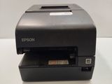 a black printer sitting on top of a white table
