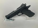 the gun is next to a lighter on a clear stand