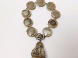 a close up of a necklace on a white surface