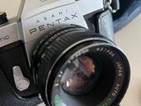 a camera that is sitting on a table next to a cell phone