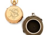 an antique pocket watch with a gold case and a black enamel case