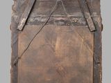 an old wooden box with a metal handle on a gray background
