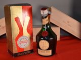 a bottle of wine sitting next to a box on a table
