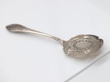 a spoon that is sitting on top of a piece of paper